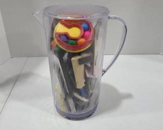 Plastic pitcher full of refrigerator magnets including Fisher Price touch magnets from 1995