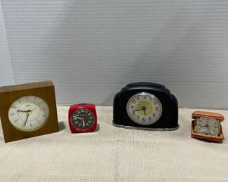 Clocks Bulova, Crosley, red plastic Bulova. Travel clock is missing a hinge
