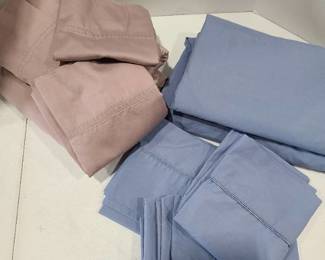 Two queen size sheet sets. Blue set has 3 pillowcases