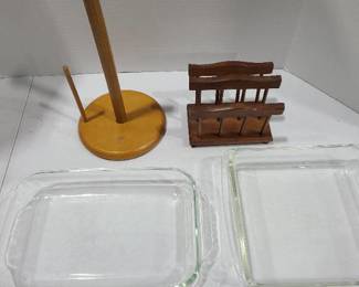 Two Pyrex baking dishes, wooden paper towel holder and wooden napkin holder