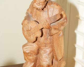 Carved wooden man playing banjo