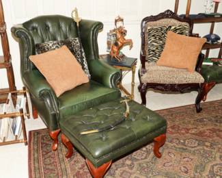 There are two custom dark green tufted leather chairs with ottomans available - in great condition!