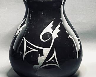  sleek black vase features unique etched Native American designs, and glossy finish. 