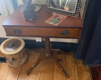 One drawer, tri leg mahogany stand.  decorated stoneware that needs repair.