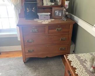 Dresser with mirror. Item to right forefront family took.  