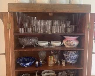 This is the interior photo of previous cupboard with collection of white ironstone, part of collection of spatter ware and sponge ware; crystal; cut glass, etc. 