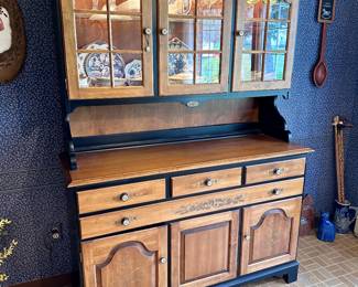 (Lot 2) $450 - Hitchcock Hutch Cabinet.  Beautiful Hitchcock black and harvest lighted cabinet in excellent condition, 2 pc top hutch and bottom buffet base.   53” x 19” x 76”