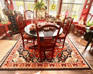Round black table with leaf that stores under the table top and 5 red painted chairs- table is so separately from the chairs