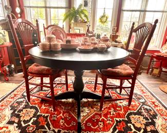 Round black table with leaf that stores under the table top