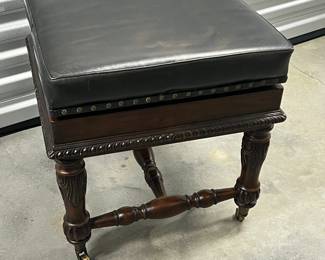 Leather Ottoman on caster- top flips to a checker game board. Asking $100. 