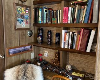 books, bear skull, hunting/wildlife patches on the wll, more antlers, cast iron Clydesdales & wagon, bentwood chair, mugs & steins on top shelf (((( NOTE; the wolf fur - NOT for sale))))