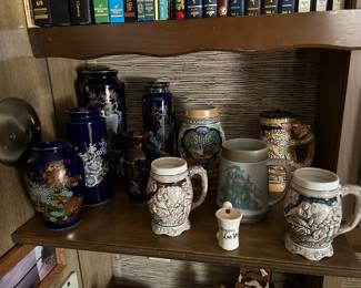 On the left or Kutani cobalt blue vases and various steins on the right.