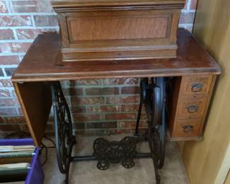 Antique sewing machine shown with cover