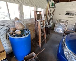 Ladders, gardening, tools, furniture, pads, gourds, pegboard, and pegs in the garage
