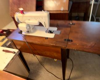 Singer, sewing machine. My mom made a lot of clothing with this