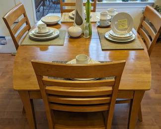 A sweet honey of a kitchen table. Big enough for elbow room. Small enough for kitchen knooks. Perfect. Size for work and crafts in between. Stained beautiful natural ash with four accommodating chairs