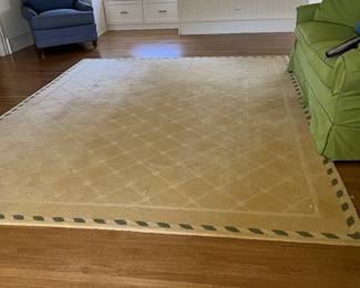 Yellow wool area rug with green border