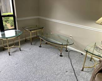 4 matching gold tone tables; 2 side, one coffee and an oval table.   Solid and nicely embelished