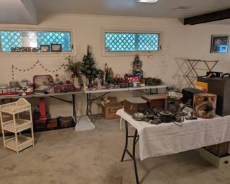 Basement main room has Christmas, lot of books, vintage cameras, old postcards, pictures etc
