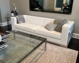 White leather couch and 51 Inch square with chrome legs and three-quarter inch glass