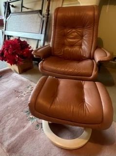 Super cool pink-ish leather chair, high-end rug