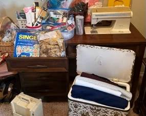 Singer sewing machine, thread spools, fabric, buttons, sewing organization