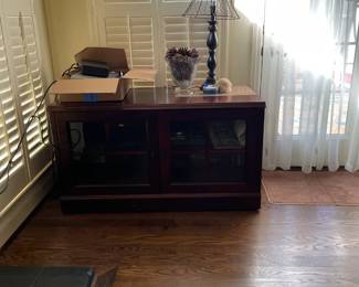 Cherry tv entertainment center with glass doors and pull out shelf.  Lamp for sale.