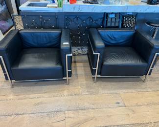 37. Pair of black leather and chrome armchairs