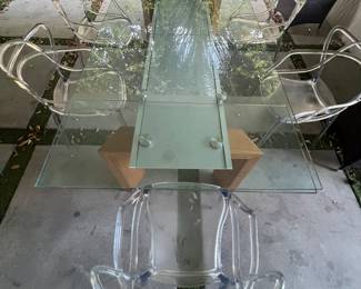 33. In view of six ghost chairs and extension glass dining table