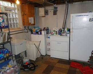 Laundry area, with lots of cleaning and laundry supplies