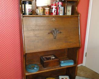 Vintage desk and or storage unit, with vintage tins, and a great shoe form too.  Just look at the upper left.