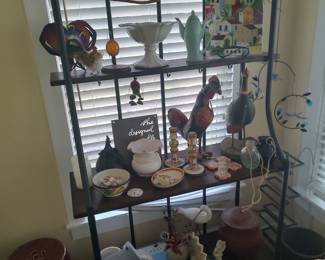 Bakers rack holding a substantial grouping of folk pottery items from the 20th century.