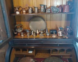 Substantial collection of copper kitchen wares from the 19th and 20th centuries displayed on a fine Victorian period secretary with a cylinder enclosure, circa 1870.