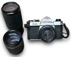 Vintage Asahi Pentax 35mm Film Camera Model: K1000 w/ A Pentax 50mm F/2 SMC M K Mount Manual Focus Lens, A Soligor C/D Zoom Macro 95-210mm F4.5 Telephoto Zoom Lens, And A Takumar (Bayonet) 1:2.5 135mm Asahi Optical Co. Lens
