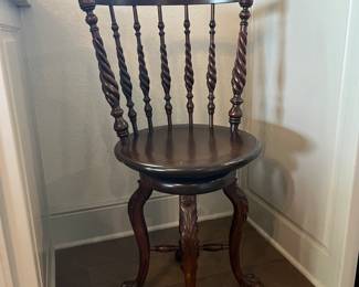 unique antique four-legged stool with turned back spindles