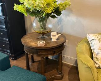 round side table with green floral arrangement