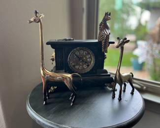 brass giraffes and table clock