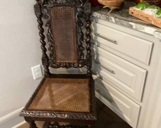Intricate carved thrown chair with cane seating
