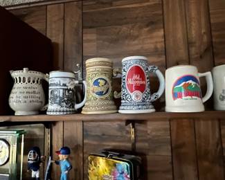 Pokémon lunchbox, couple of bobble heads… Between the bobble heads is a Waterford shot glass (or toothpick holder if you have class) and inside of it is a really cool metallic blue vintage Parker mechanical pencil.