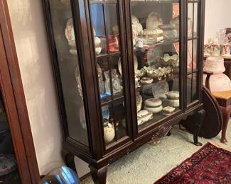 Beautiful display case full of porcelain and glass including wave crest
