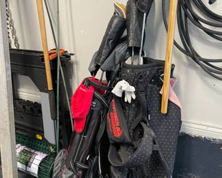 Numerous men's golf clubs, bags, balls, and associated golf gear.