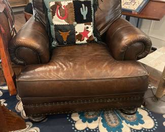 Another photo of leather chair - extra deep, in excellent condition. Also pictured - adorable Western inspired pillow with black suede fringe.