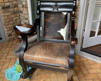 Cowhide and leather carved wooden rocking chair.