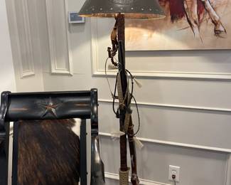 Floor lamp with long gun, rattlesnake skin, stirrup, spurs, and tack - too fun! 