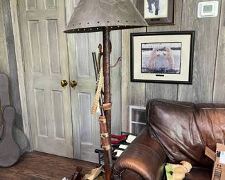 Unique floor lamp with long gun, rattlesnake, spurs, stirrups and other Western accents. Truly a conversation piece!