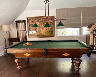 Billiards Table: A walnut wood handcrafted table by Adler, with green felt inlay and brown leather ball cages, including accessories like pool sticks and a holder.