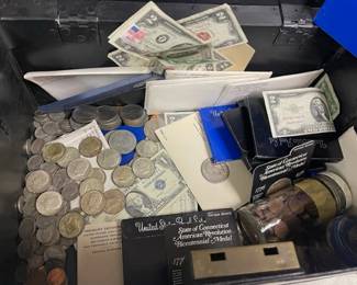 Coin and Currency lot.  Contents $5 dollar silver certificates, $2 dollar bills, commemorative coins , wheat pennies and more. STRONG BOX NOT INCLUDED