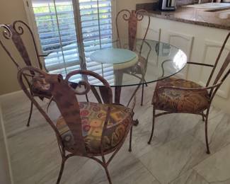 Glass Top Kitchen table with four Iron chairs.