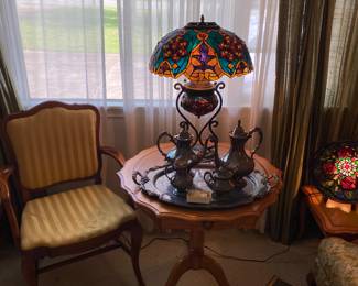 Beautiful Tiffany style stained glass lamp.
Silver Tea Service
Pie Crust Leather Top Table