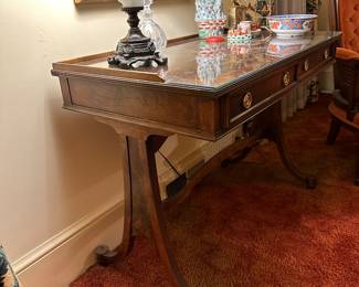 A custom Baker Regency mahogany and satinwood sofa table turned desk. (There’s no drop leaves…)
